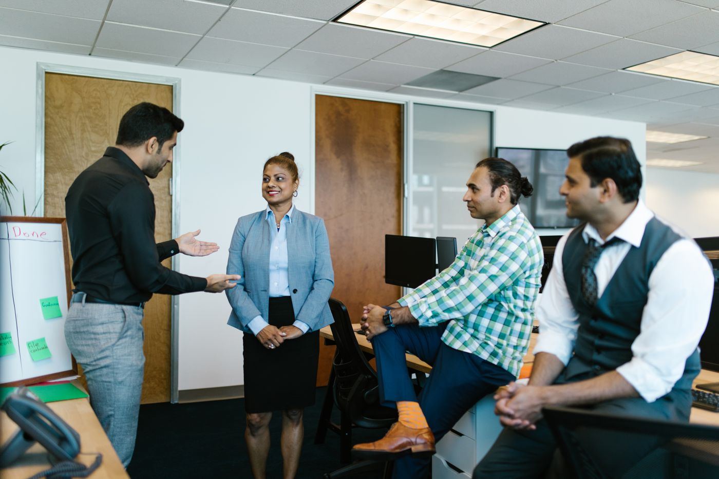 Colleagues talking together in a modern office