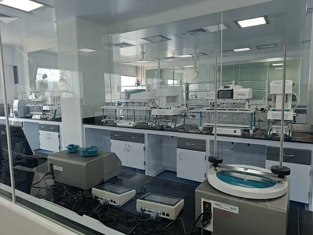 Quality control laboratory with instruments behind glass partitions