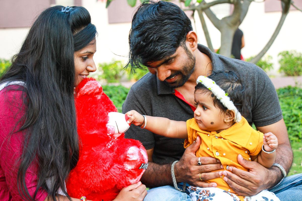 Young parents enjoying time outdoors with their baby daughter
