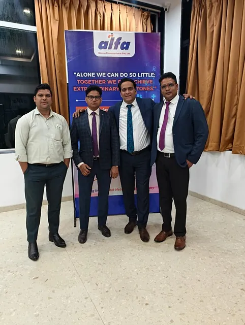 Alfa Biomed leaders in front of the Alfa banner